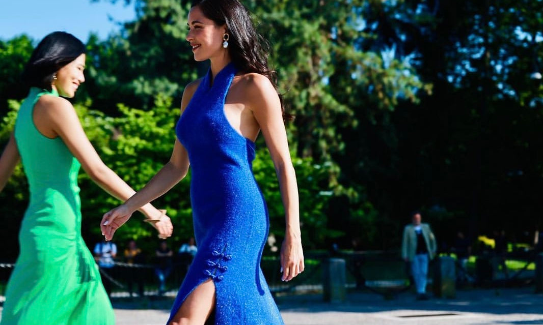 Two models in blue and green Sense By Mei dresses stand confidently, embodying the brand's commitment to empowering women through fashion.