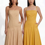 Two professional women modeling elegant square-neck spaghetti strap maxi dresses in khaki and mustard yellow, featuring a pleated A-line silhouette and side pockets for a sophisticated summer look.
