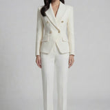 A professional woman wearing a sophisticated cream white double-breasted tweed blazer, featuring elegant gold buttons, a tailored slim fit, and classic flap pockets for a polished executive look.