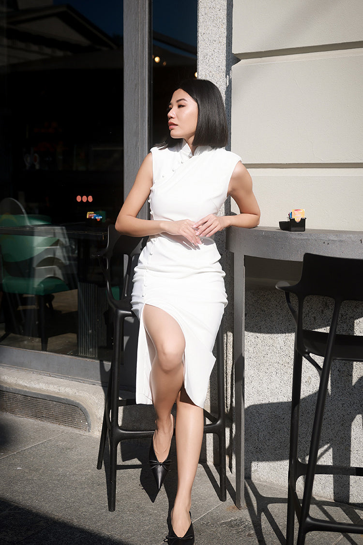 Autumn New Arrival: Petite modern Cheongsam dress with semi-high collar and 'Slim It' tailoring, modeled by a seated woman in white, showcasing the elongated neckline and delicate design