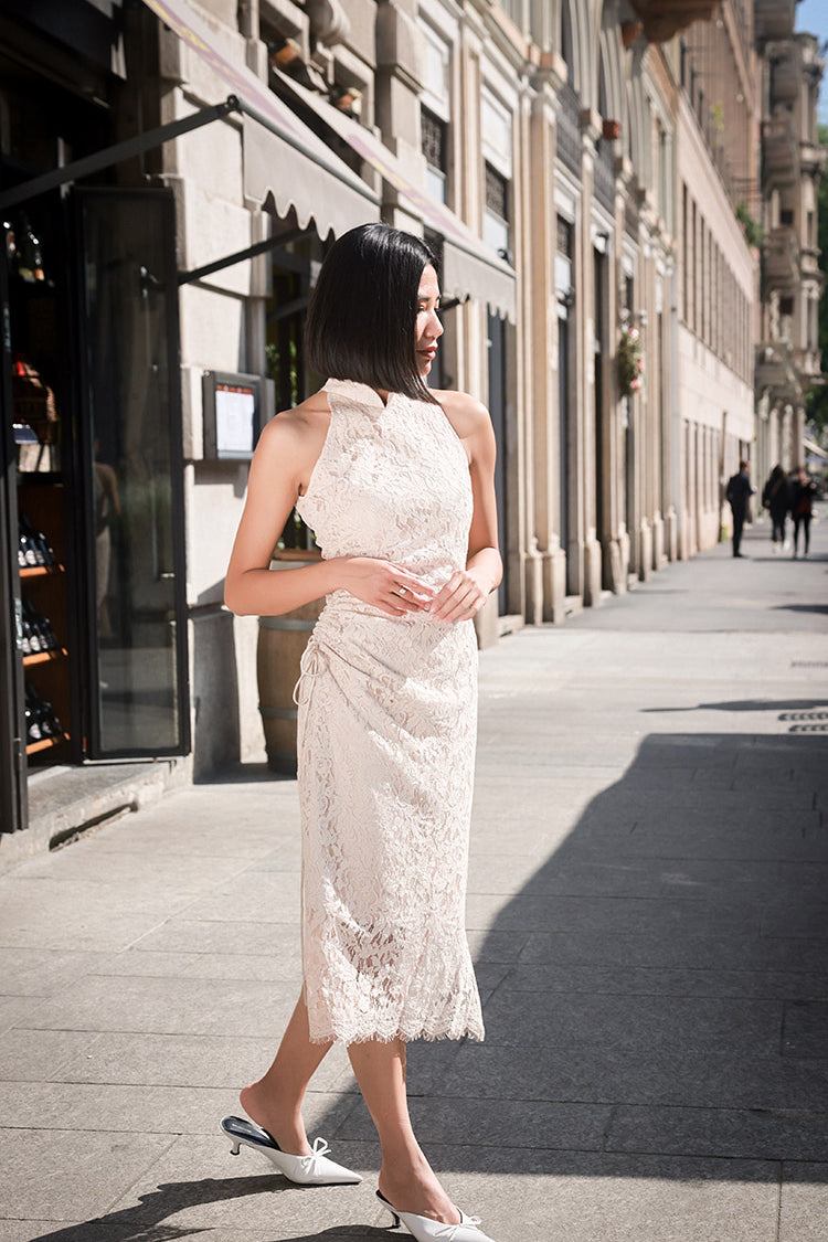 Side view of the elegant off-shoulder white Cheongsam, highlighting the sculpted silhouette and side pleats that enhance the figure.