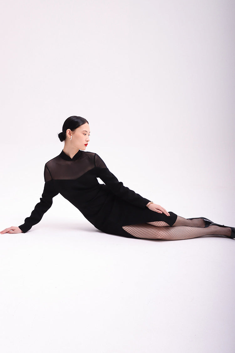 Black Cheongsam-clad model sitting on the ground, showcasing the premium acetate-polyester fabric and the dress's breathable, flattering fit.