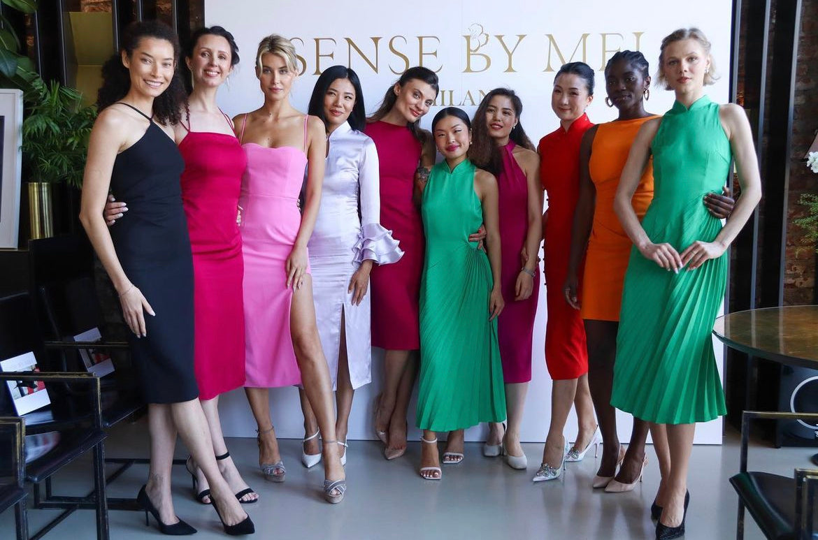 A vibrant ensemble of models gathered at an event, each adorned in Sense By Mei's exquisite dresses, showcasing the brand's diverse and elegant collection.
