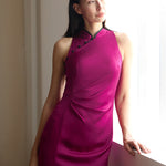 Half-body shot of a model in a soft silk Cheongsam dress by a window, the exclusive BYMEI pink complementing the natural light and emphasizing the dress's elegant, non-fluorescent hue.