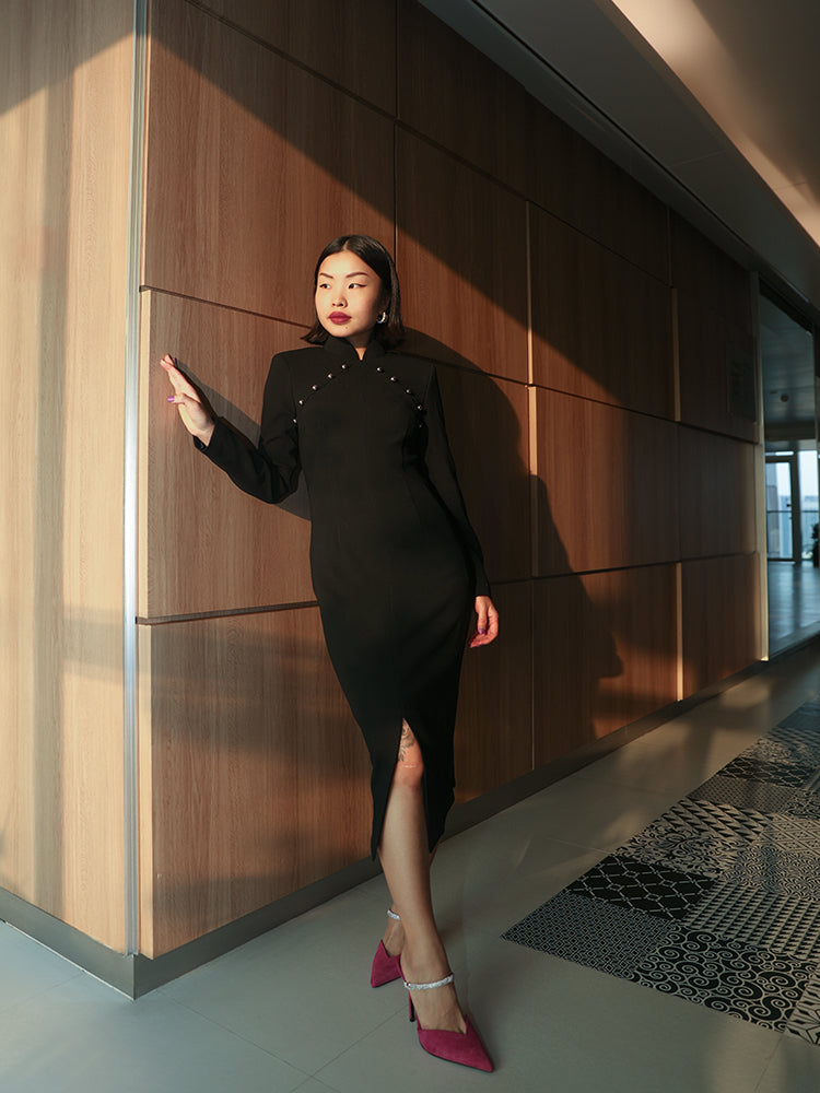 A sophisticated black qipao dress blending traditional elegance with modern design.