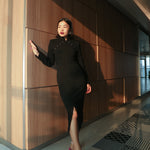 A sophisticated black qipao dress blending traditional elegance with modern design.