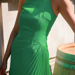 Close-up of the model's upper body in a green Cheongsam dress, featuring handcrafted pleats and a chic shoulder cut design, reflecting modern elegance.