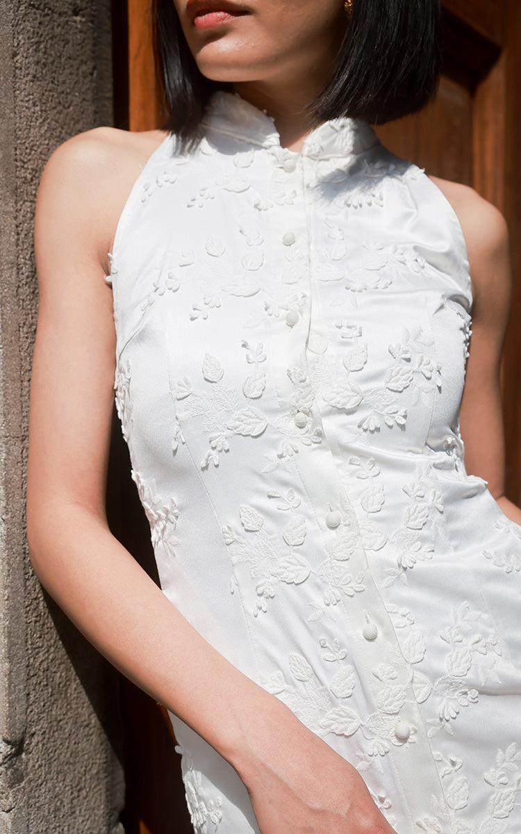 Close-up half-body shot of a model in a Modern Chinese Elegance Cheongsam, focusing on the high-quality satin and detailed embroidery of the dress