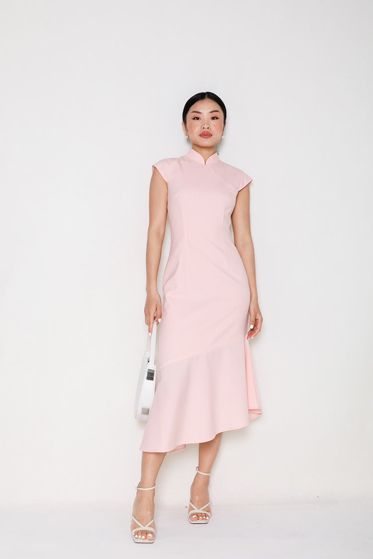 Full-length view of a model against a white background, dressed in a pink modern Cheongsam mermaid dress, highlighting the blend of classical Chinese design and contemporary silhouette.