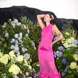 Model in a rose red silk organza floral Cheongsam dress, serenely closed eyes, basking in the sunlight amidst blossoms.