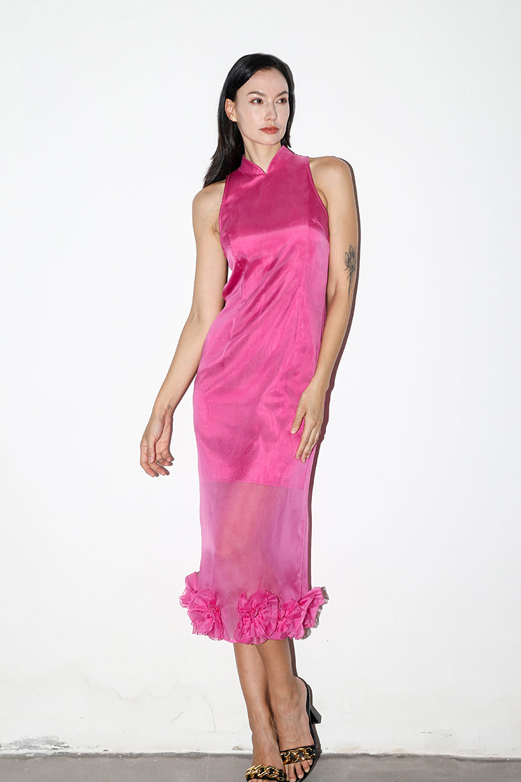 Model posing in a rose red silk organza Cheongsam with floral details, featuring a modern shoulder-cut design, against a white background.