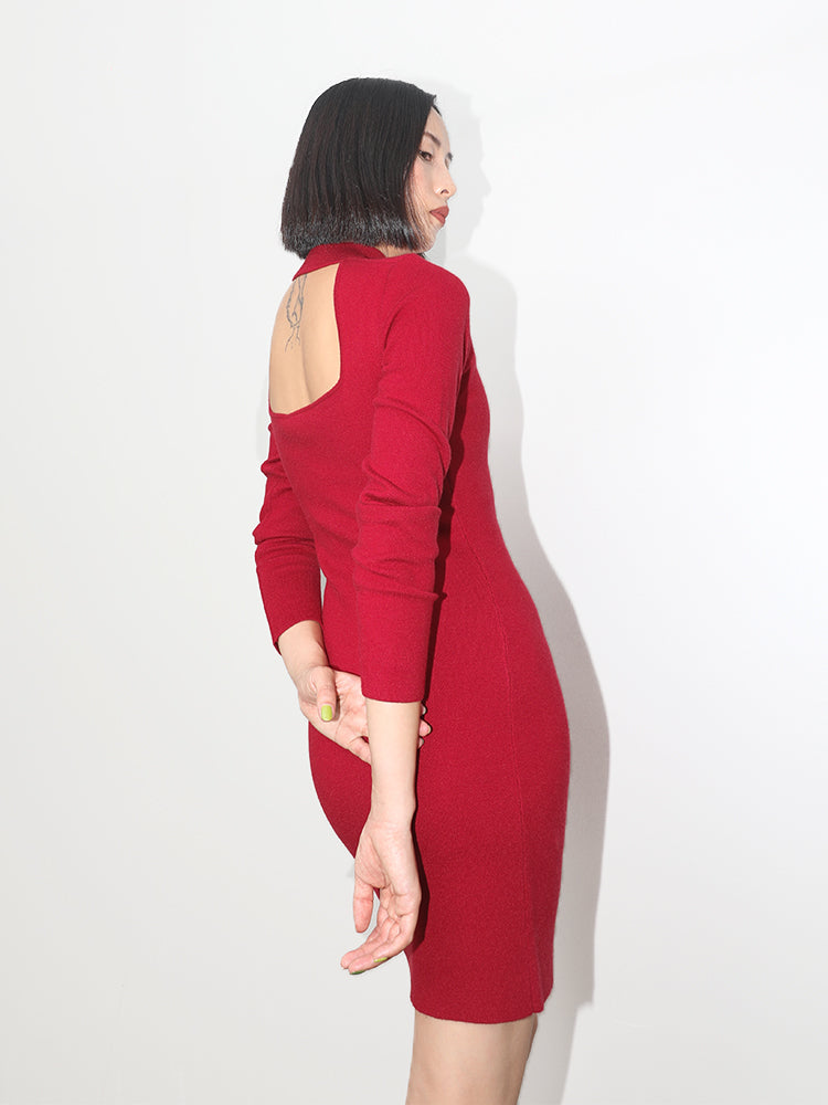 Minimalist fashion shot of a woman wearing a red backless knit midi dress, emphasizing the seamless construction and snug fit.