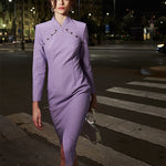 Tailored qipao dress in lavender, exuding modern elegance in an outdoor setting.