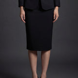 A professional woman wearing a sophisticated high-waisted pencil skirt in a cream white color, featuring a tailored slim fit and knee-length hem for an elegant office look.