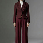 A professional woman wearing a sophisticated burgundy blazer suit with a classic shawl lapel and a white turtleneck, perfect for a high-end executive office look.