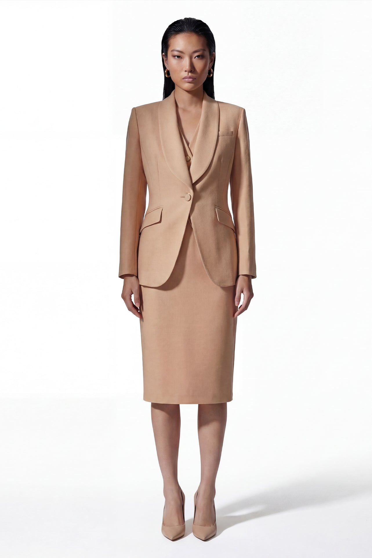 A professional woman wearing a sophisticated apricot high-waisted pencil skirt with a tailored slim fit, part of an elegant business suit for executive office wear.
