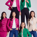 A professional woman wearing a sophisticated beige modern Qipao-inspired skirt suit, featuring a tailored blazer with traditional Chinese frog buttons and a stand collar for an elegant executive office look.