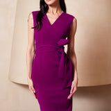 A professional woman wearing a sophisticated magenta v-neck sleeveless midi dress, featuring a tailored slim-fit pencil silhouette for a polished executive office or cocktail look.