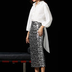 A woman wearing a glamorous high-waisted pencil skirt featuring shimmering silver and black sequins in a stylish zebra print, ideal for an elegant evening party or a night out.