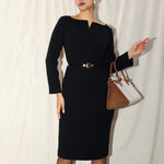A professional woman wearing a sophisticated black long-sleeve midi dress, featuring a unique notched square neckline and a tailored slim-fit pencil silhouette for a polished executive office look.