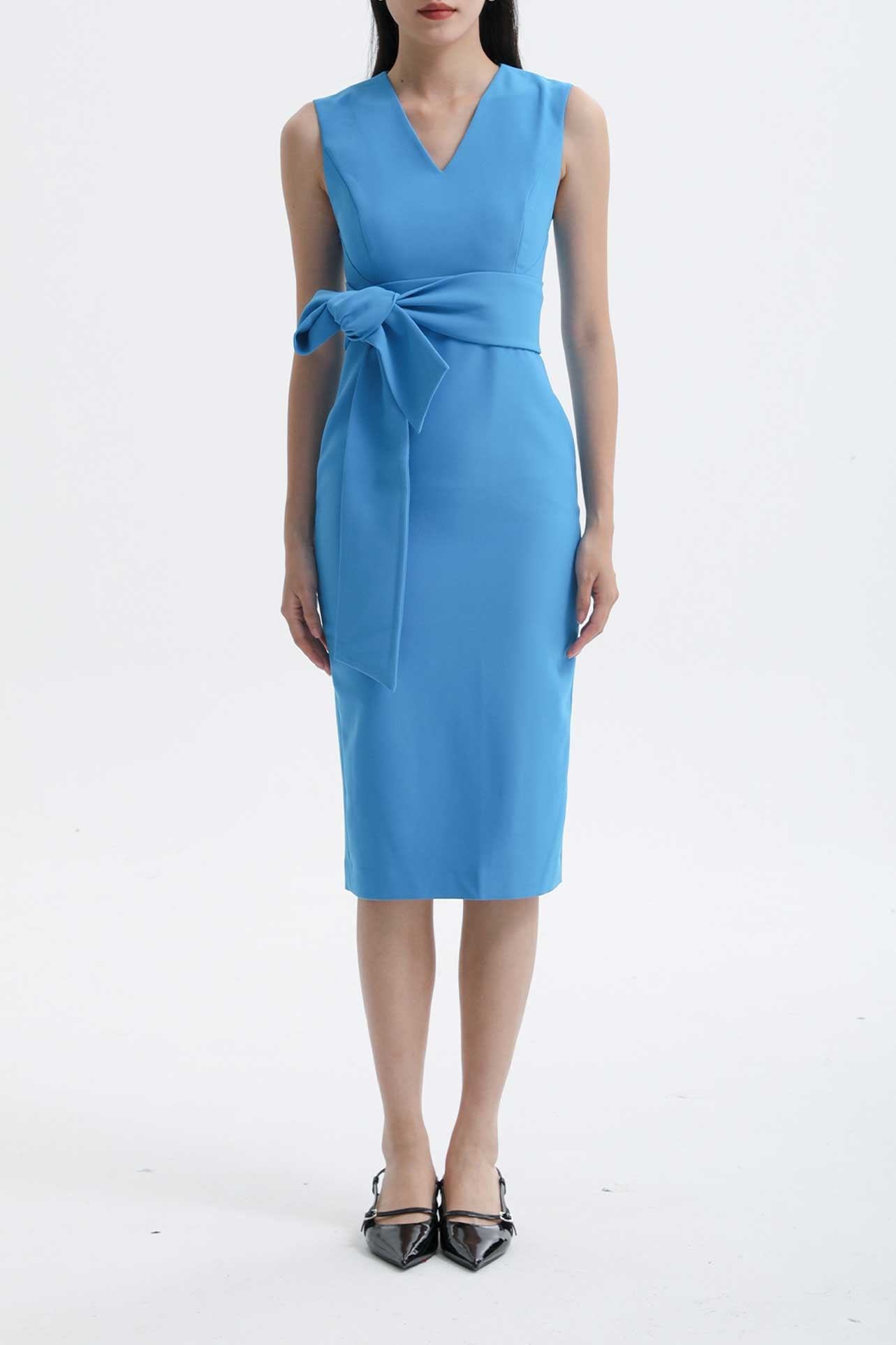 Four women showcasing an elegant v-neck sleeveless sheath dress in black, burgundy, teal green, and lavender pink, featuring a slimming tie-waist design perfect for a modern professional office look.