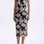 A professional woman wearing a stunning black sleeveless qipao-inspired dress, featuring a chic halter neck with a traditional mandarin collar and large elegant white floral embroidery for a modern oriental evening look.