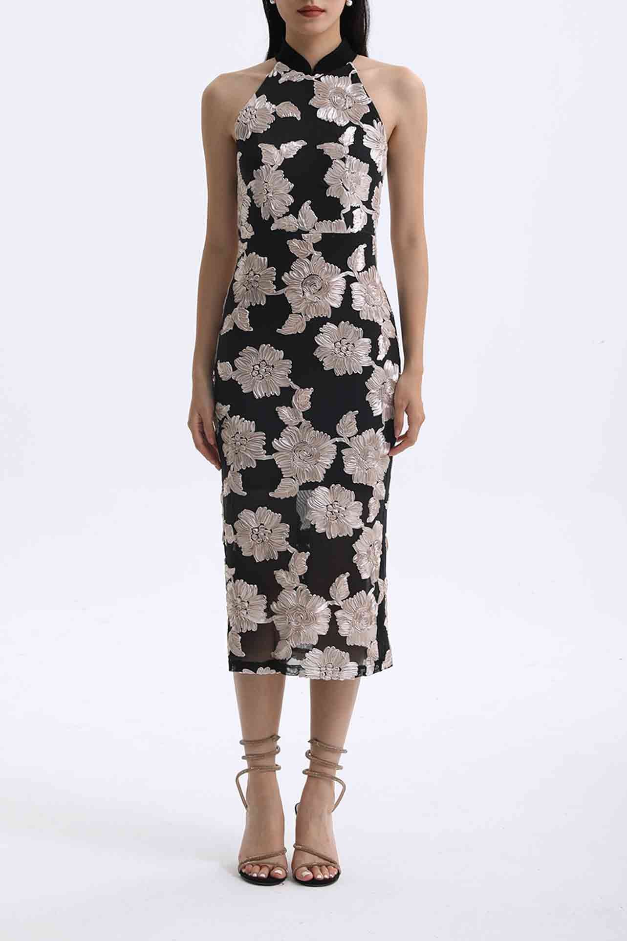 A professional woman wearing a stunning black sleeveless qipao-inspired dress, featuring a chic halter neck with a traditional mandarin collar and large elegant white floral embroidery for a modern oriental evening look.