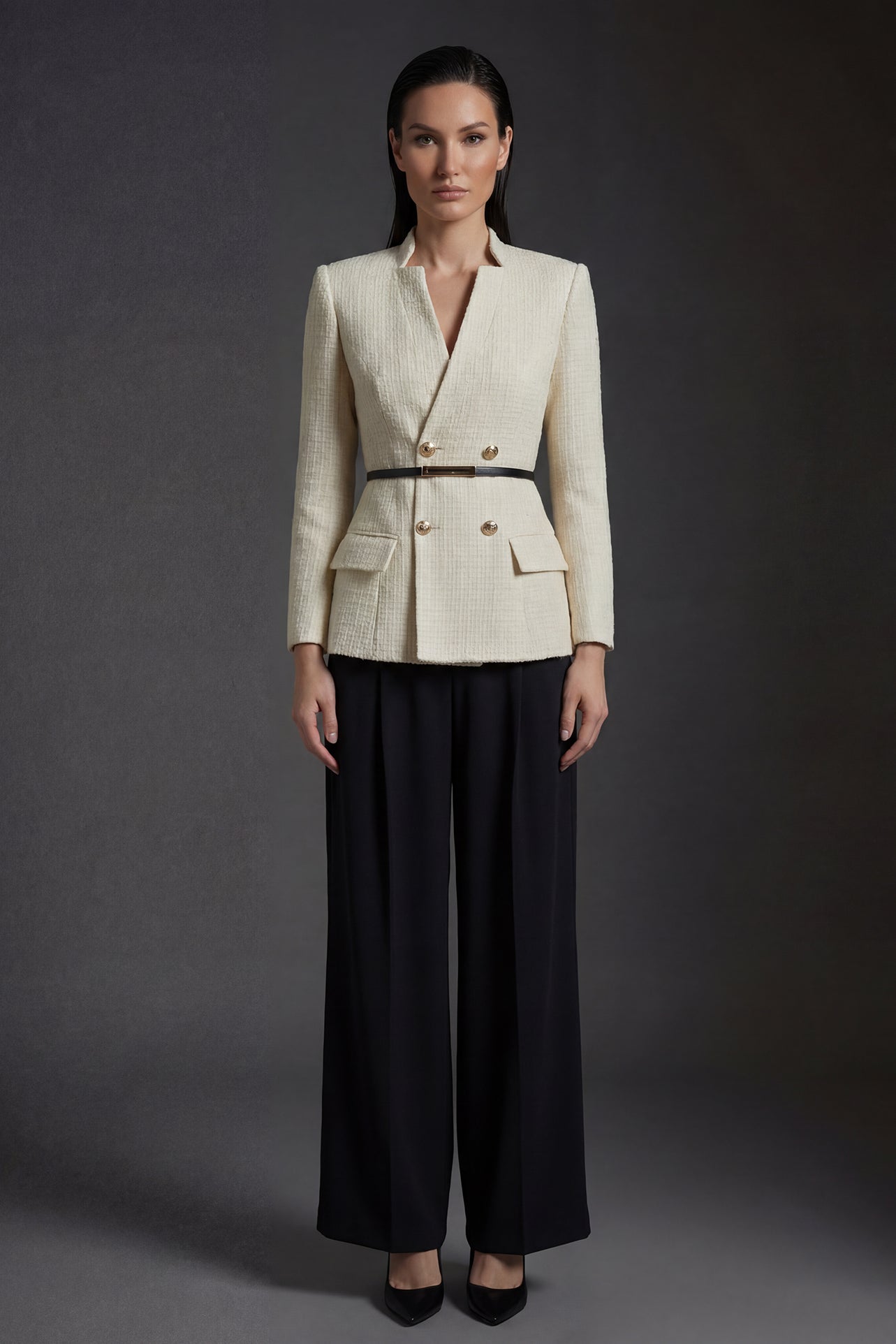 A professional woman wearing a sophisticated cream white tweed skirt suit, featuring a double-breasted blazer with gold buttons, a slim black belt, and an elegant polka dot pussy bow tie for a polished French chic office look.