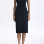 A professional woman wearing a sophisticated navy blue midi dress, featuring an elegant pleated neckline with a subtle keyhole detail and a tailored slim-fit pencil silhouette for a polished executive look.