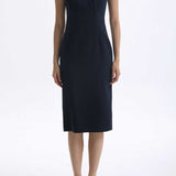 A professional woman wearing a sophisticated navy blue midi dress, featuring an elegant pleated neckline with a subtle keyhole detail and a tailored slim-fit pencil silhouette for a polished executive look.