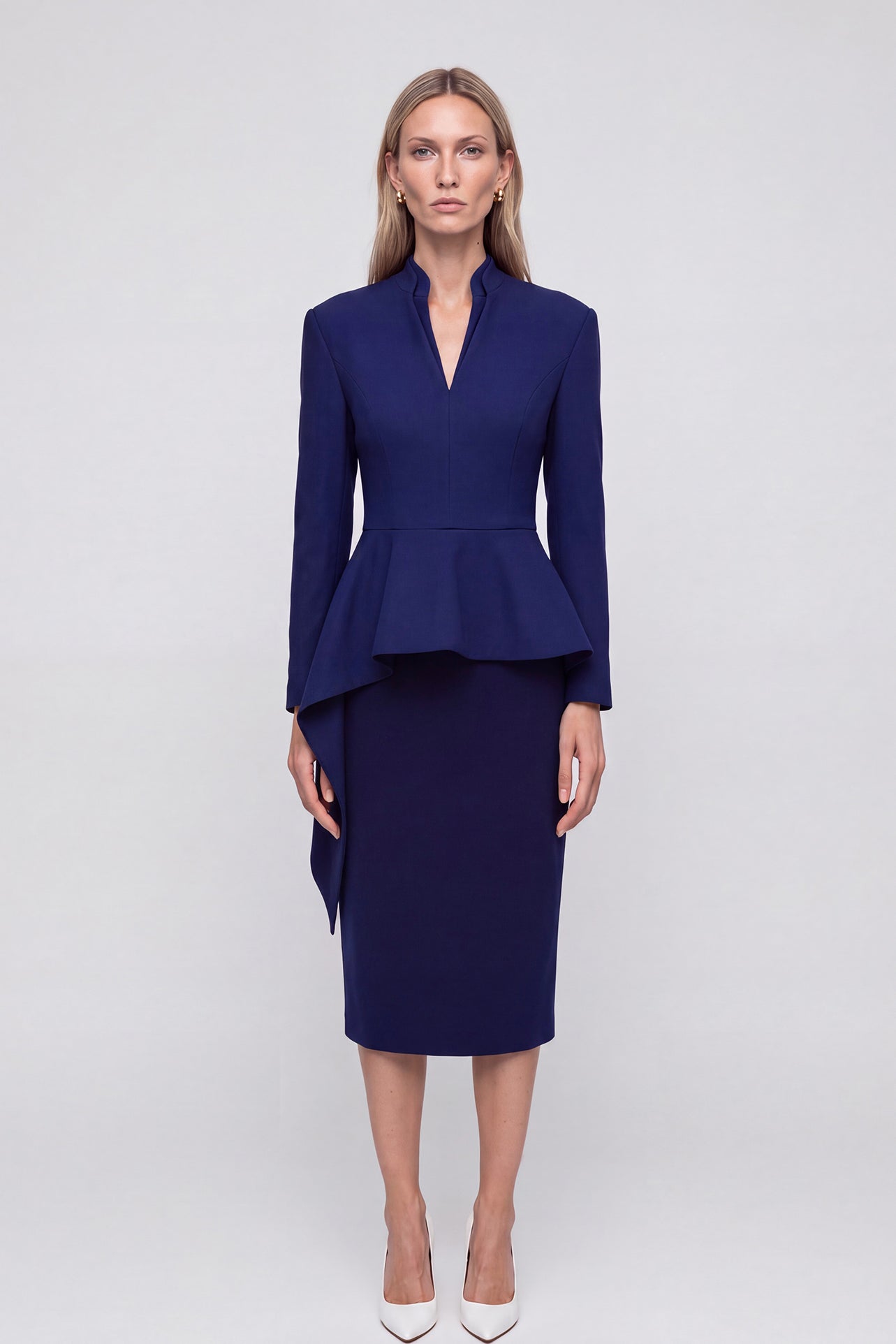 A professional woman wearing a classic navy blue high-waisted tailored pencil midi skirt with subtle front darts, neatly paired with a crisp white long-sleeve button-down shirt for an elegant corporate look.