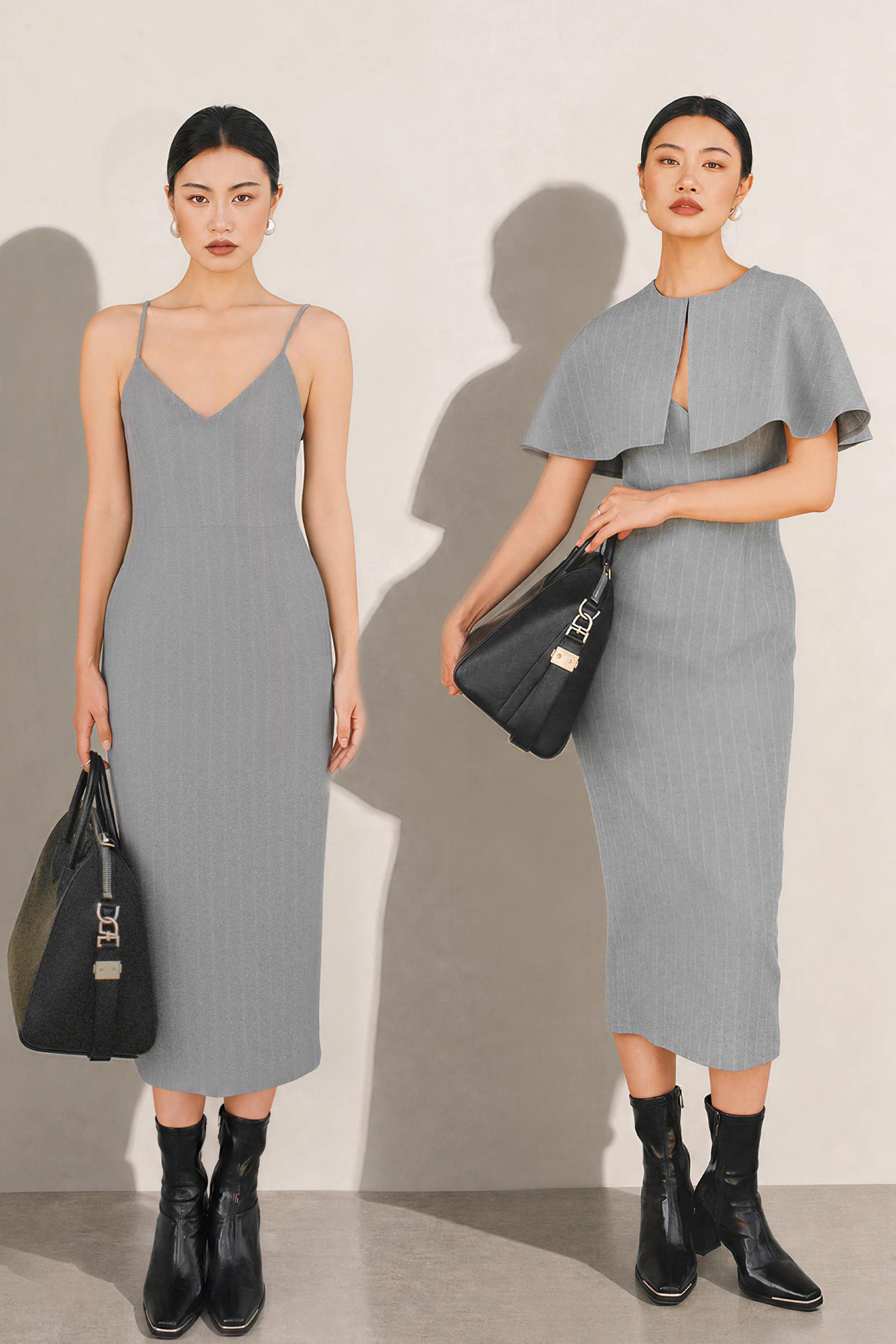 A stylish woman walking on a city street wearing an elegant light grey sheath midi dress with a sophisticated capelet sleeve design, round neckline, and side slit, carrying a black leather handbag.