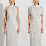 A professional woman modeling an elegant white lace halter neck modern qipao dress, featuring a sophisticated mandarin collar with keyhole detail and an intricate eyelet embroidered fabric for a quiet luxury look.