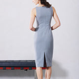 A professional woman wearing a sophisticated light grey pinstripe sleeveless sheath dress, featuring an elegant boat neckline and a tailored slim-fit silhouette for a polished executive look.