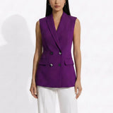 A professional woman modeling an elegant deep purple sleeveless double-breasted blazer vest, featuring a notched lapel, front flap pockets, and a slim belt, paired with white tailored trousers for a sophisticated office look.