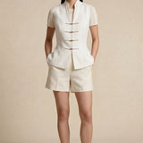 A professional woman modeling stylish high-waisted wide-leg trousers in a classic black pinstripe pattern, featuring sophisticated front pleats and a flattering long-line silhouette for an elegant office look.