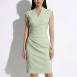 A professional woman modeling an elegant navy blue double-breasted trench dress, featuring a sophisticated notched lapel, a structured belt, and a pleated A-line skirt for a polished executive office look.
