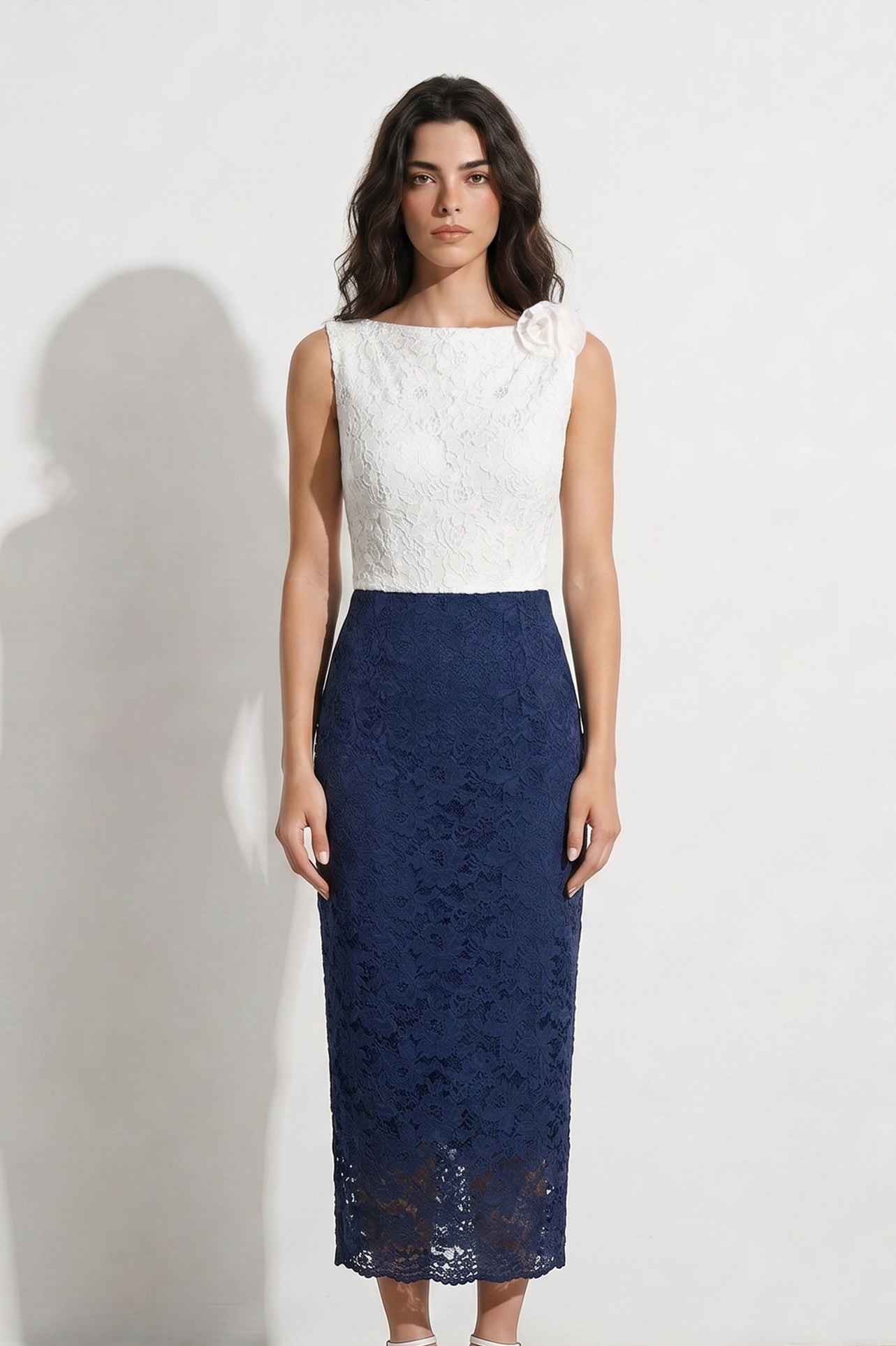 A style comparison of two professional office outfits: the left showing a sleeveless color-block lace dress with a white 3D flower bodice, and the right featuring a rich purple satin wrap halter top paired with the same navy blue lace pencil skirt for a sophisticated corporate look.