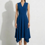 A professional woman modeling an elegant royal blue sleeveless V-neck dress, featuring a tailored fit-and-flare silhouette and a flowing midi A-line skirt for a sophisticated office or social look.