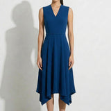 A professional woman modeling an elegant royal blue sleeveless V-neck dress, featuring a tailored fit-and-flare silhouette and a flowing midi A-line skirt for a sophisticated office or social look.