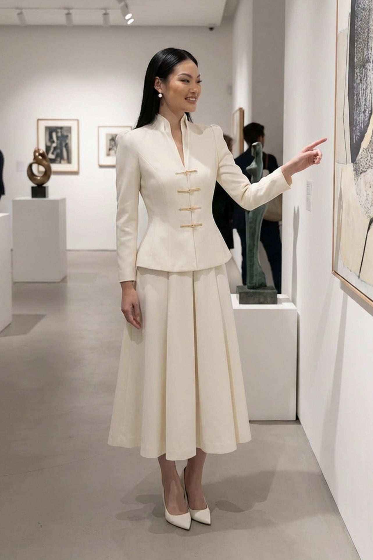 A sophisticated woman enjoying coffee in Paris wearing an elegant cream white modern qipao suit, featuring a mandarin collar blazer with traditional frog buttons and a matching pleated skirt for a quiet luxury oriental look.