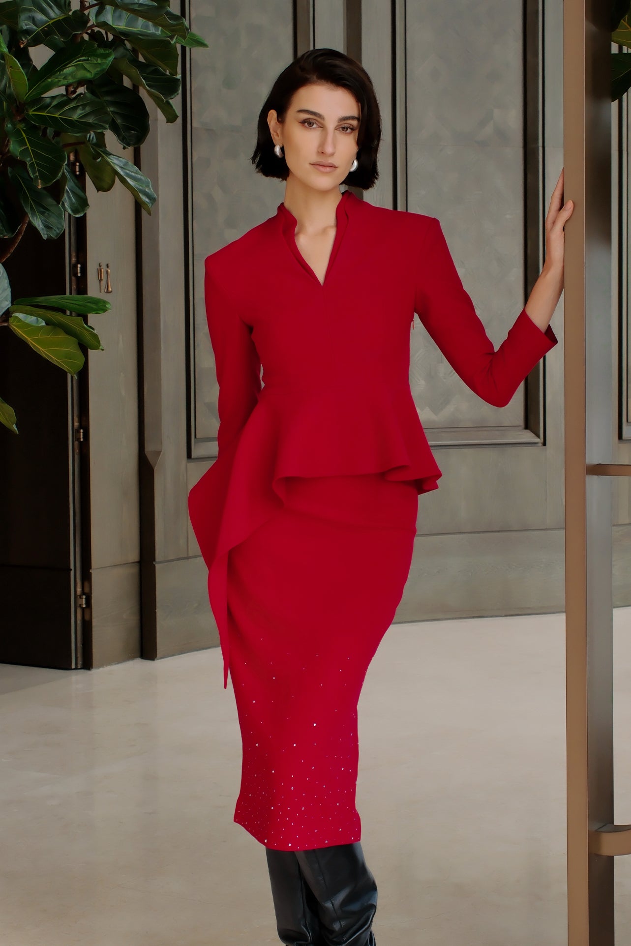 A style comparison of two elegant women's high-waisted pencil midi skirts featuring a delicate gradient of sparkling rhinestones at the hemline; shown on the left in deep red paired with a white shirt, and on the right in pale ice-blue paired with a matching peplum top.