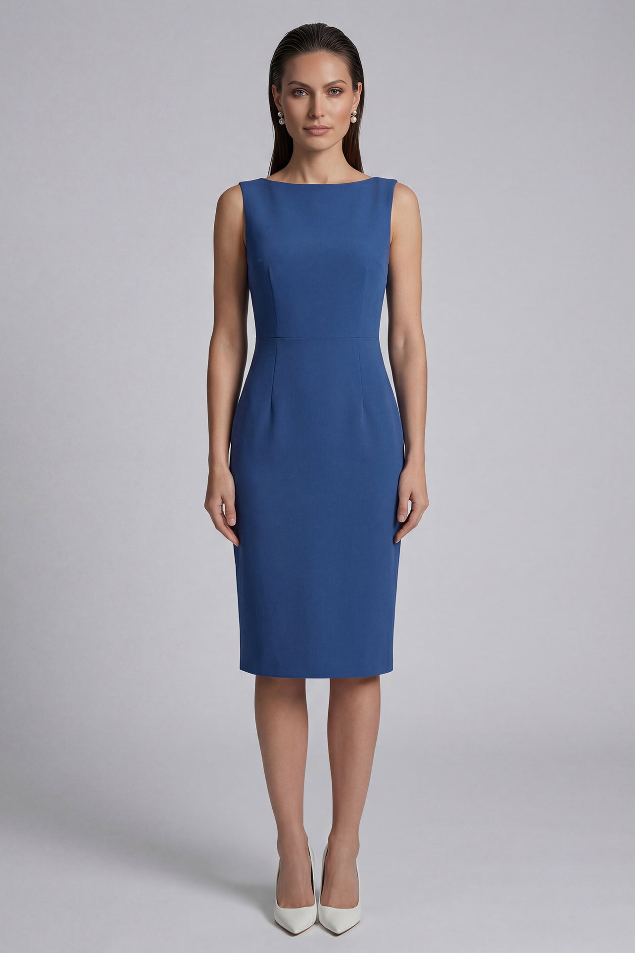 A professional woman wearing a sophisticated teal blue midi dress with an elegant cape-style overlay and structured shoulders, perfect for formal executive events and ceremonial occasions.