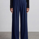 Comparison of elegant navy blue and ivory cream high-waisted wide-leg trousers, featuring sophisticated pleated front details and a tailored relaxed fit for professional office wear.