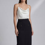 A professional woman wearing a sophisticated high-waisted white pencil skirt featuring elegant double-breasted button decorations and a slimming tailored fit, ideal for corporate business wear.