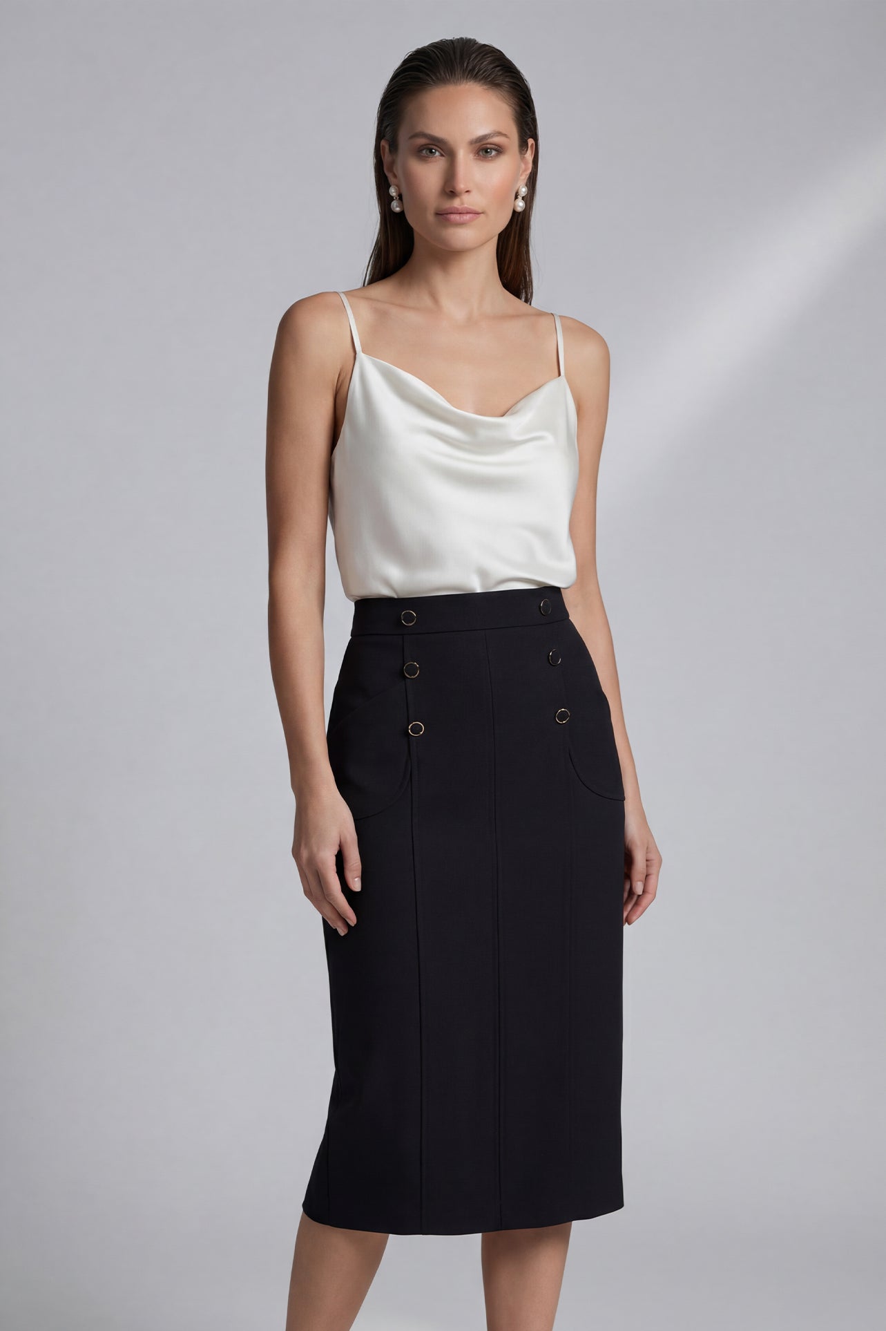 A professional woman wearing a sophisticated high-waisted white pencil skirt featuring elegant double-breasted button decorations and a slimming tailored fit, ideal for corporate business wear.