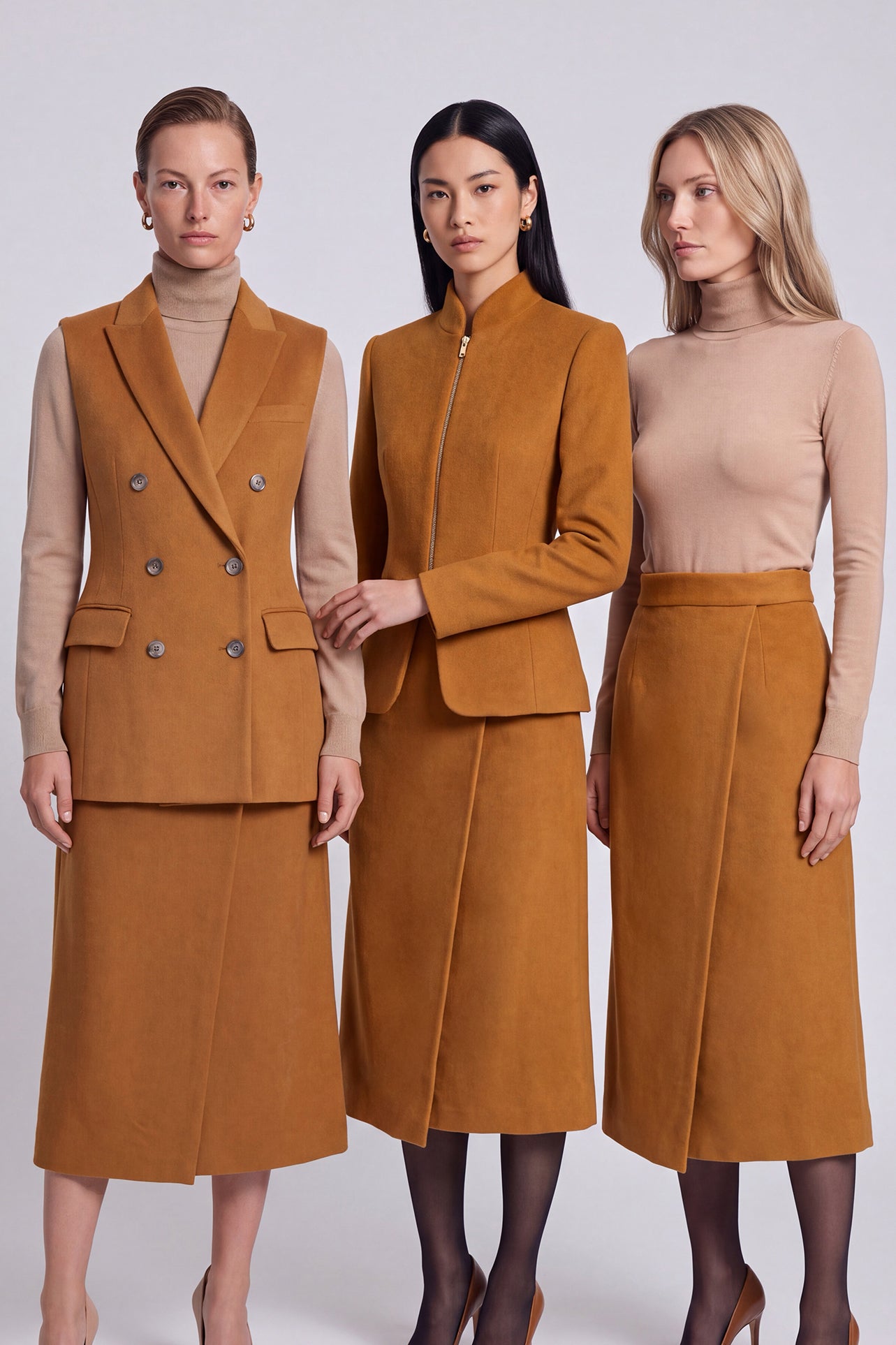 An elegant Asian woman posing in a luxurious camel wool two-piece suit featuring a sleeveless double-breasted longline vest cinched with a wide black belt, paired with a matching midi column skirt and black opera gloves.