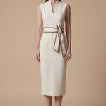 A professional woman modeling an elegant white sleeveless midi dress, featuring a sophisticated stand collar with a V-neck slit and a chic brown contrast bow belt for a polished office look.