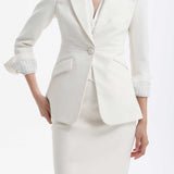 A professional woman wearing a sophisticated black belted blazer dress, featuring a tailored slim-fit silhouette with a waist-defining belt for a powerful executive business look.