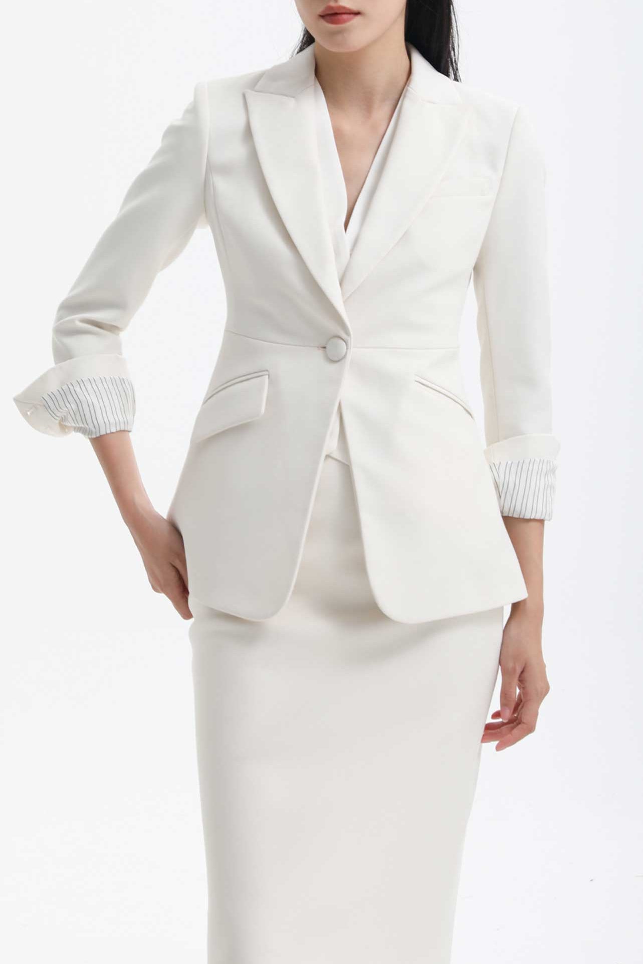 A professional woman wearing a sophisticated black belted blazer dress, featuring a tailored slim-fit silhouette with a waist-defining belt for a powerful executive business look.